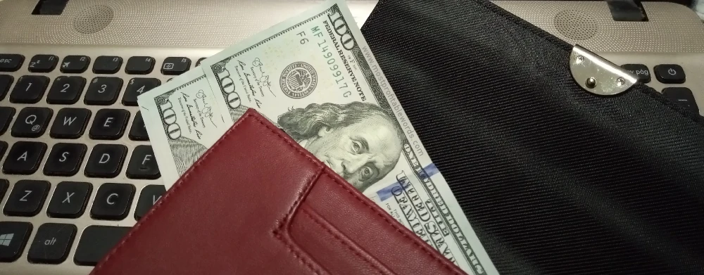 Dollars in a wallet earned from copywriting